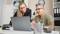 Man and woman business workers working together using laptop at the office Royalty Free Stock Photo