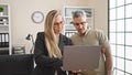 Man and woman business workers working together using laptop at the office Royalty Free Stock Photo