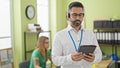 Man and woman business workers working using touchpad and headphones at office Royalty Free Stock Photo