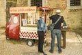 Man and woman buying wine from small stall located in St George` Royalty Free Stock Photo