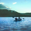 A man and a woman are canoeing on a mountain lake. Beautiful landscape of a mountain lake in Norilsk, Taimyr Royalty Free Stock Photo