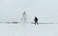 Man and woman in casual clothes having fun in nature on a frozen snowy lake Royalty Free Stock Photo