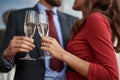 Man and woman celebrating with champagne glasses outdoor