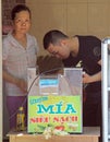 Man and woman are checking the automatic filling machine in Vinh, Vietnam