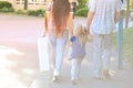man and woman with child, happy family together walks along city street, blurred overexposed image, concept of family serene Royalty Free Stock Photo