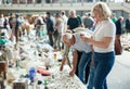 Man and woman choosing interesting souvenirs at traditional flea market