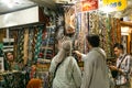 Man and woman choosing and negotiating Kain Batik at PasarBeringharjo traditional market, Yogyakarta