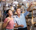 Man and woman is choosing new chandelier for her home in store Royalty Free Stock Photo