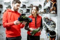 Man and woman choosing shoes for mountain hiking