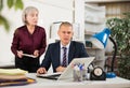 Man and woman clerical workers in office