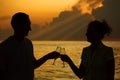 Man and woman clink glasses. Silhouettes on sea