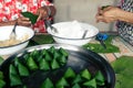 Man and woman are confederate to Wrapped in local sweets with banana leaf In occasion of Family Day and Songkran Festival of