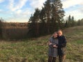 Man and the woman in country clothes on a background of early spring Pine hill