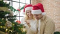 Man and woman couple decorating christmas tree at home Royalty Free Stock Photo