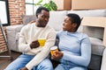 Man and woman couple drinking coffee sitting on floor at new home Royalty Free Stock Photo