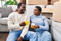 Man and woman couple drinking coffee sitting on floor at new home Royalty Free Stock Photo