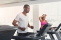 Man and woman, couple in gym on treadmills