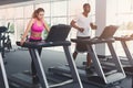 Man and woman, couple in gym on treadmills