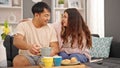 Man and woman couple having breakfast smiling at home