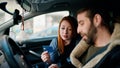 Man and woman couple holding credit card driving car at street Royalty Free Stock Photo