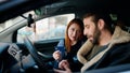 Man and woman couple holding credit card driving car at street Royalty Free Stock Photo