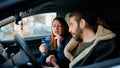 Man and woman couple holding credit card driving car at street Royalty Free Stock Photo