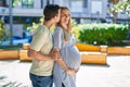 Man and woman couple hugging each other expecting baby at park Royalty Free Stock Photo
