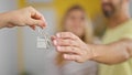 Man and woman couple hugging each other receiving new house keys at new home Royalty Free Stock Photo