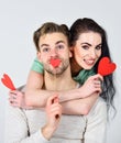 Man and woman couple in love hug and hold red heart valentines cards close up. Valentines day concept. Man and pretty Royalty Free Stock Photo