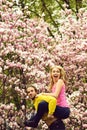 Man and woman, couple in love in spring magnolia flowers Royalty Free Stock Photo