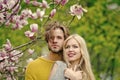 Man and woman, couple in love in spring magnolia flowers Royalty Free Stock Photo