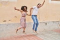 Man and woman couple smiling confident jumping at street Royalty Free Stock Photo