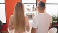 Man and woman couple standing together backwards at dinning room Royalty Free Stock Photo