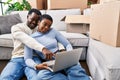 Man and woman couple using laptop sitting on floor at new home Royalty Free Stock Photo