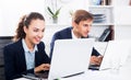 Man and woman coworkers working on computers Royalty Free Stock Photo