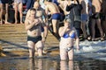 Man and woman cross themselves plunging into icy water during the feast Epiphany on the Dnieper River