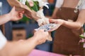 Man and woman customer paying for boquet of flowers at flower shop Royalty Free Stock Photo