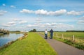Man and woman cycle on a bike path at the top of a Royalty Free Stock Photo