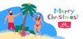 Man and woman decorate palm tree on the tropical beach merry christmas