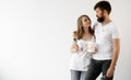 A man and a woman in dirty T-shirts stand on a white background and hug. Home renovation concept. Baner. Royalty Free Stock Photo