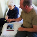 Man and woman discuss technology of iPhone and iPad