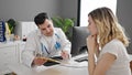 Man and woman doctor and patient having consultation showing medical report at clinic Royalty Free Stock Photo