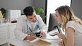 Man and woman doctor and patient having consultation showing medical report at clinic Royalty Free Stock Photo