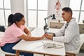 Man and woman doctor and patient having medical consultation with hands together at clinic Royalty Free Stock Photo