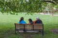 Man, Woman, Dog on Bench in Park Royalty Free Stock Photo