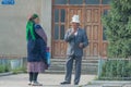 A man and a woman dressed in traditional Kyrgyz clothes in Bokonbayevo, Kyrgyzstan