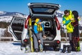 man and woman dressing into ski equipment near suv car Royalty Free Stock Photo