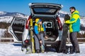 man and woman dressing into ski equipment near suv car Royalty Free Stock Photo