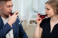 A man and a woman drink red wine at an elegant family gathering. Royalty Free Stock Photo