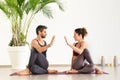 Man and woman duo doing yoga stretching exercises